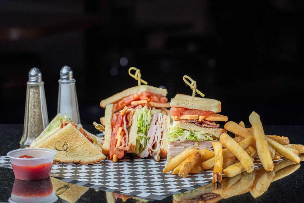 Club Sandwich · Ham, turkey, bacon, American cheese piled high on potato bread with lettuce, tomato, and mayo.