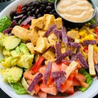 Southwest Chicken Salad · Grilled Southwest chicken, romaine lettuce, black beans, corn, diced tomatoes, avocado, tort...