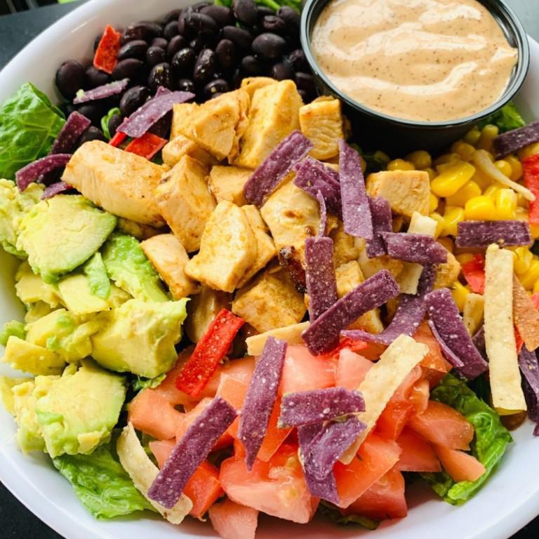 Southwest Chicken Salad · Grilled Southwest chicken, romaine lettuce, black beans, corn, diced tomatoes, avocado, tortilla strips with our homemade signature chipotle ranch dressing.