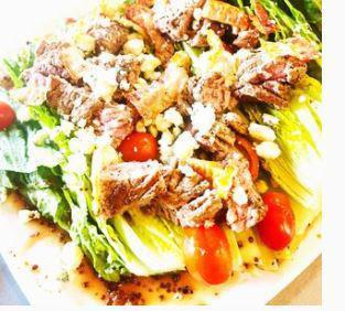 Filet Wedge Salad · 8 oz. beef filet sliced and served on top of romaine wedge with grape tomatoes, bacon, crumbly bleu cheese, and balsamic vinaigrette dressing.