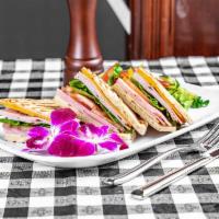 Monte Cristo Panini · Turkey, ham, Swiss cheese, cheddar cheese, lettuce, tomato and honey mustard. Served with ch...