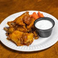 Hot Wings · 12 crispy deep fried chicken wings tossed in our house-made hot wing sauce. Served with cele...