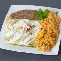 Enchiladas Suizas · Filled with shredded chicken in a tomato chipotle sauce and topped with green sauce, melted ...