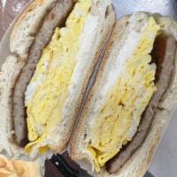Sausage, Egg and cream cheese  · 2 scrabbled eggs with sausage and cream cheese on a light toasted roll. 