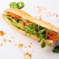 Sauteed Tofu Egg Sandwich · Baguette roll, margarine, cucumber, jalapeño topped with pickled carrot, cilantro, green oni...