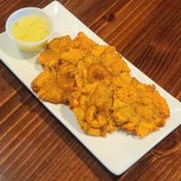 Fried Smashed Plantains · Crispy Golden Plantains Served with a side of our Homemade Garlic Sauce