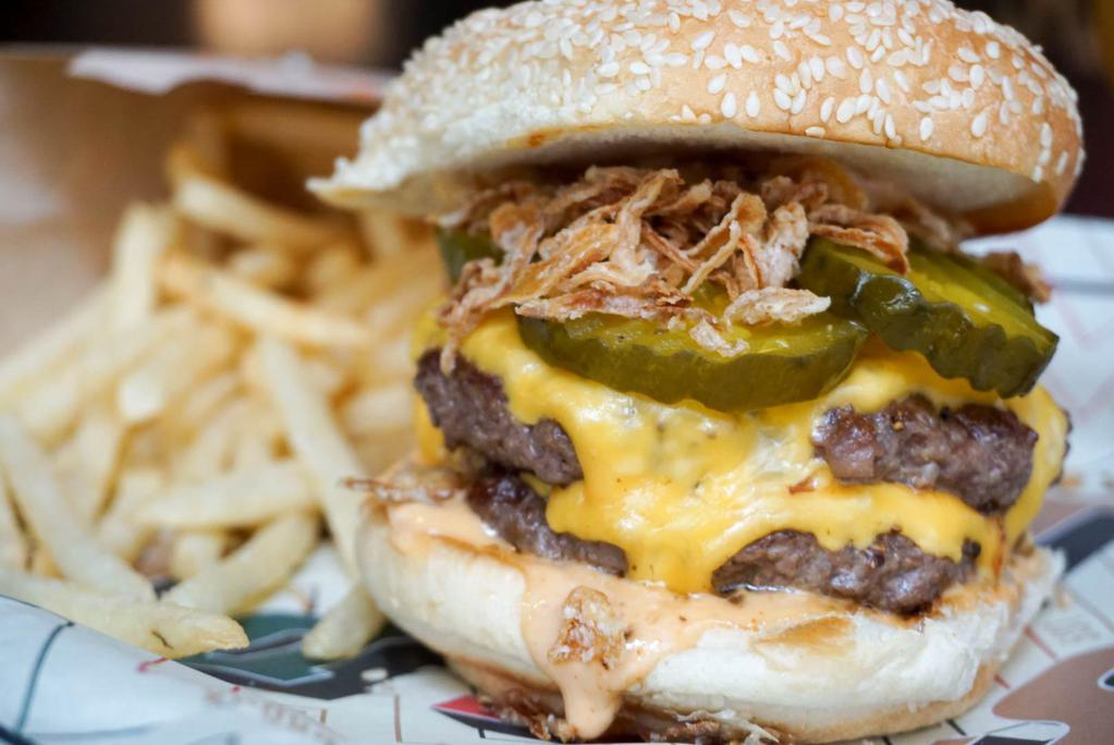 The Double Smashed Burger · Burger bash winner! 2 beef patties, American cheese, CH sauce, crispy shallots, bread and butter pickles, sesame seed bun.