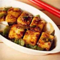 Chilli Paneer · Deep fried battered paneer cooked in sauce made with hot sauces, onion, and peppers.