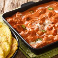 Paneer Butter Masala · Fried paneer cooked in creamy onion-tomato sauce finished with mild Indian spices.