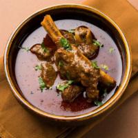 Kadai Goat Curry-Bone · Goat cooked with onion tomato chunks finished with Indian spices.