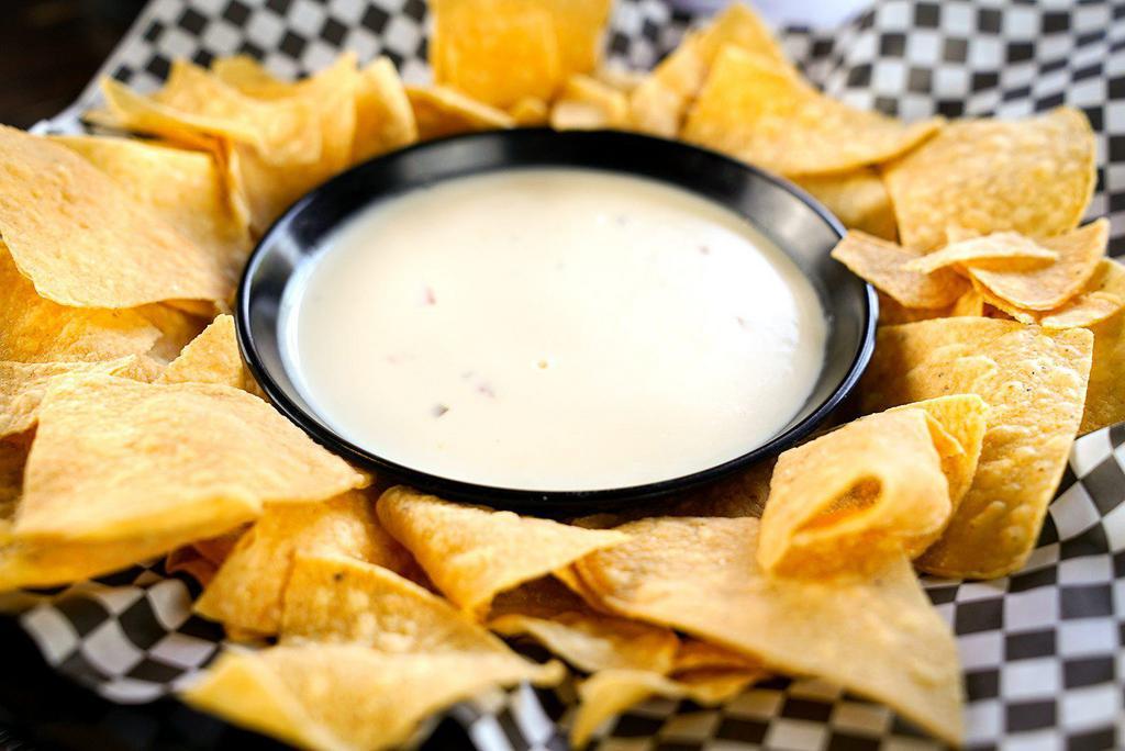 Crispy Chips and Queso · Crispy corn chips with our spicy queso