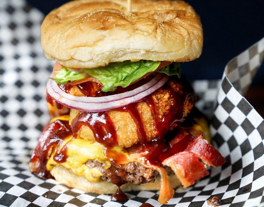 Rodeo Burger · Onion rings, bacon, BBQ sauce, pepper jack cheese, on a brioche bun 
