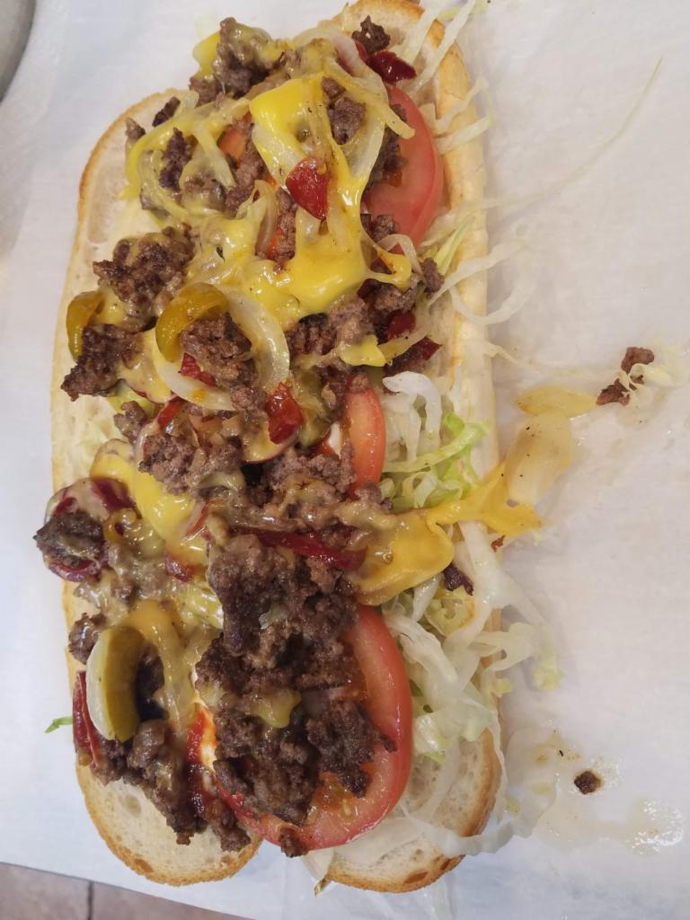 Chopped Cheese · Grilled chop meat, grilled onions
smothered in melted american cheese with lettuce & tomatoes,
Mayo & ketchup.
