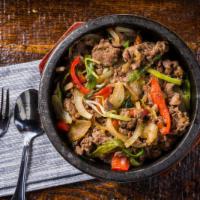 Bulgogi Over Rice · Steamed White Rice topped with Vegetables and thinly sliced
beef Ribe-Eye.