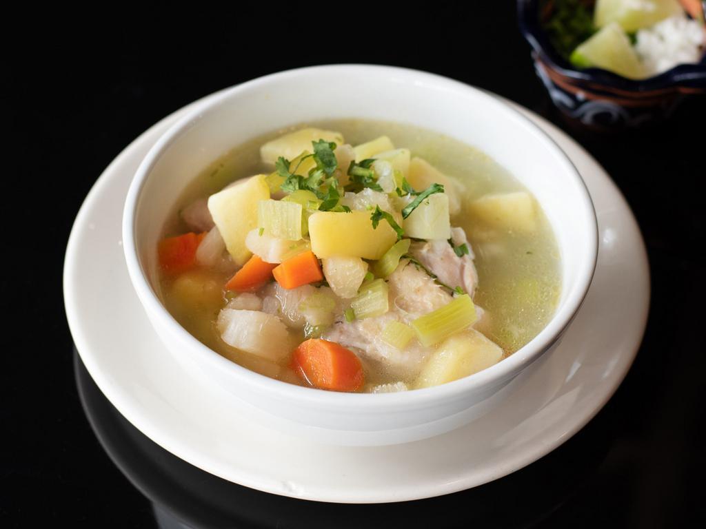 Sopa de pollo · Chicken soup with vegetables and Mexican seasonings.