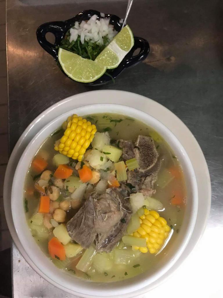 Mole de olla verde · Beef soup made with green tomato, corn, carrots, potatoes, cabbage and zucchini.
