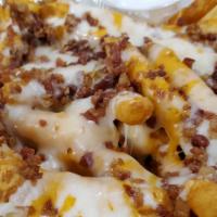 Loaded Seasoned Fries · Crispy, hot fries topped with cheddar and mozzarella cheeses and crispy bacon. Served with a...