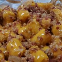 Loaded Tots · Heaping portion of tater tots fried golden brown and crispy, then drizzled with our cheddar ...