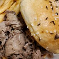Beef on Kimmelweck Sandwich · Savory sliced roast beef piled on a Kimmelweck roll with a side of horseradish and Au jus fo...