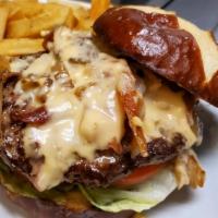 Pretzel Pub Burger · 1/2 lb Burger with bacon, lettuce, tomato & caramelized onions, topped with our delicious be...