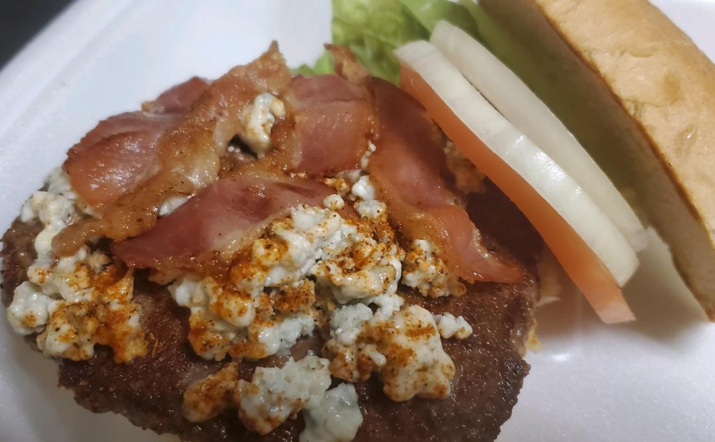 Black and Bleu Burger · 1/2 lb. juicy burger with crumbly bleu cheese, cajun seasoning and bacon. Dressed with lettuce, tomato and onion and served with fries.
