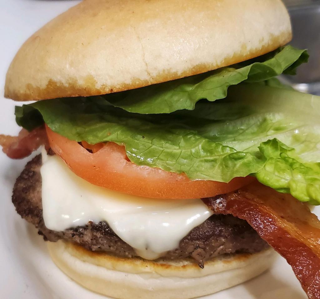 Bacon Cheeseburger · Thick 'n hearty, famous 1/2 lb. burger topped with bacon and choice of cheese. Dressed with lettuce, tomato and onion and served with fries.