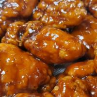 Boneless Wings · Crispy chicken tenderloins tossed in choice of famous sauce, served with celery sticks and b...