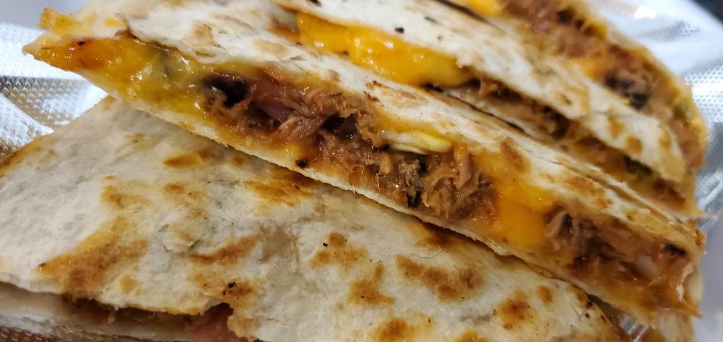 BBQ Pork Quesadilla · Grilled flour tortillas filled with melted cheddar cheese, diced jalapenos, tomatoes and onions. Sour cream and salsa on side.