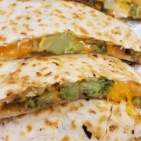 Veggie Quesadilla · Grilled flour tortillas filled with melted cheddar cheese, broccoli, diced tomatoes, onions,...