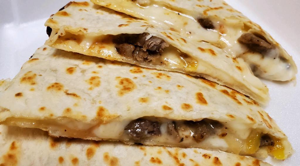 Steak Quesadilla · Grilled flour tortillas filled with melted mozzarella cheese, shaved steak, banana peppers, tomatoes, onions and country sweet sauce. Sour cream and salsa on side.