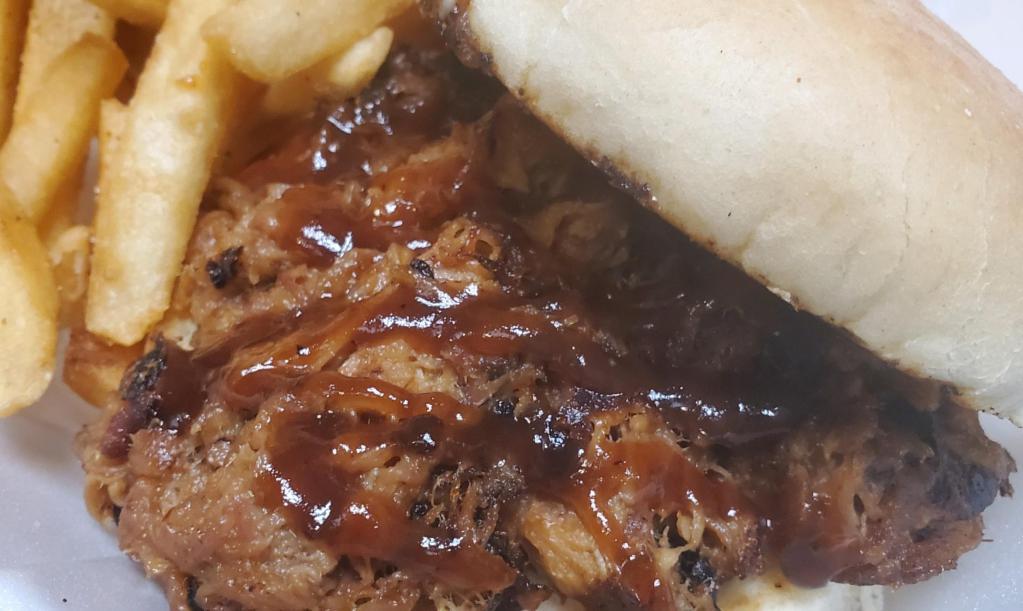 BBQ Pulled Pork Sandwich · Smoked pulled pork tossed in BBQ sauce and served on a toasted bun. Served with club fries.