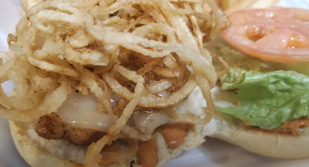 Spicy Cajun Chicken Sandwich · Grilled chicken breast, lightly seasoned with Cajun spices, topped with pepper jack cheese, crispy onion strings, lettuce, tomato and chipotle mayo. (Spicy) Served with club fries.