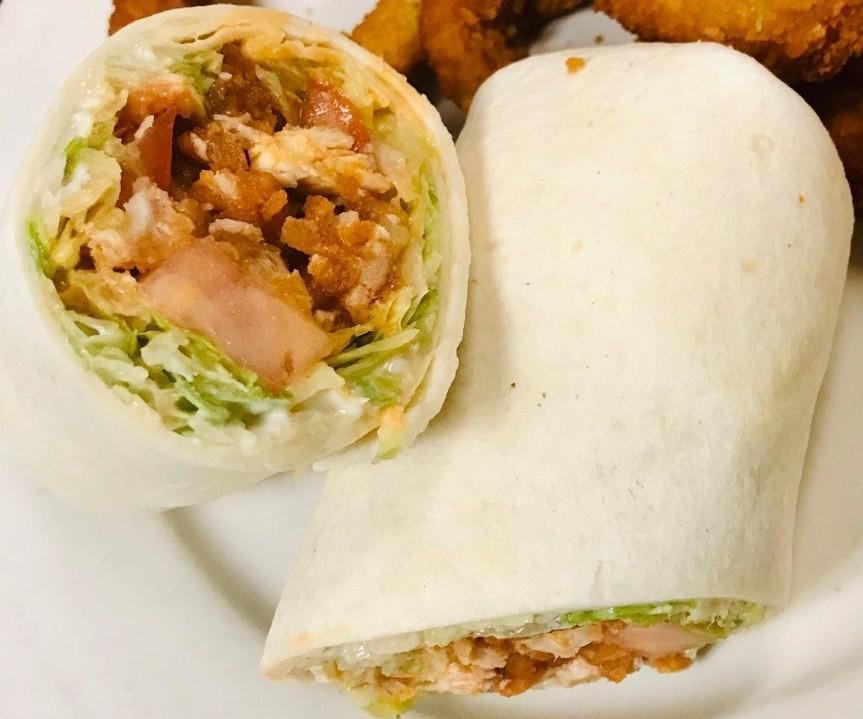 Buffalo Chicken Wrap · Crispy chicken strips tossed in mild buffalo wing sauce with creamy bleu cheese dressing, shredded lettuce, cheddar, diced celery and tomato wrapped in a warm tortilla. Served with fries.