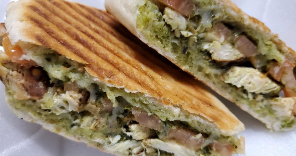 Pesto Chicken Panini · Grilled chicken breast, fresh mozzarella cheese, pesto sauce and sliced tomato all sandwiched between ciabatta bread. Served with fries.