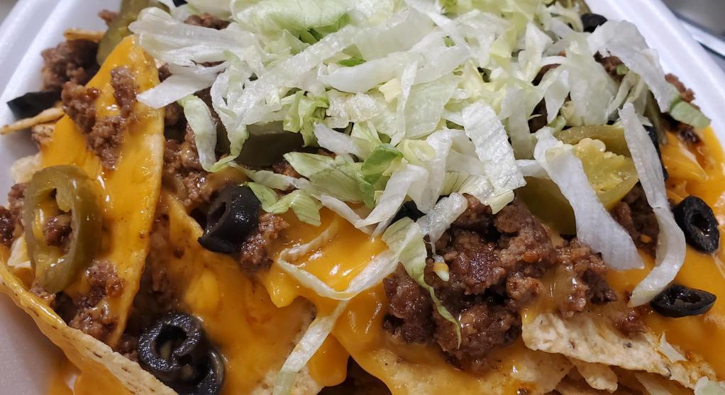 Loaded Nacho Platter · Crispy tortilla chips covered with choice of beef, chicken or pulled pork, nacho cheese, topped with olives, jalapenos, shredded lettuce, salsa and sour cream.
