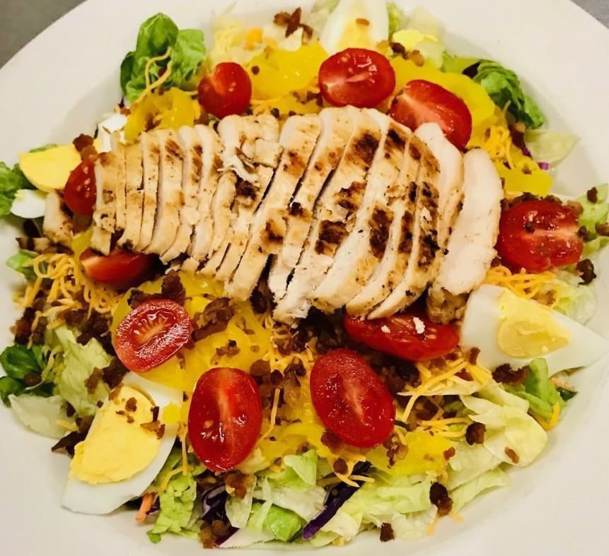 Knuckle Salad · Tossed traditional salad blend, topped with shredded cheddar cheese, grape tomatoes, cucumbers, banana peppers, bacon bits and  egg. Layered with a delicious marinated chicken breast.