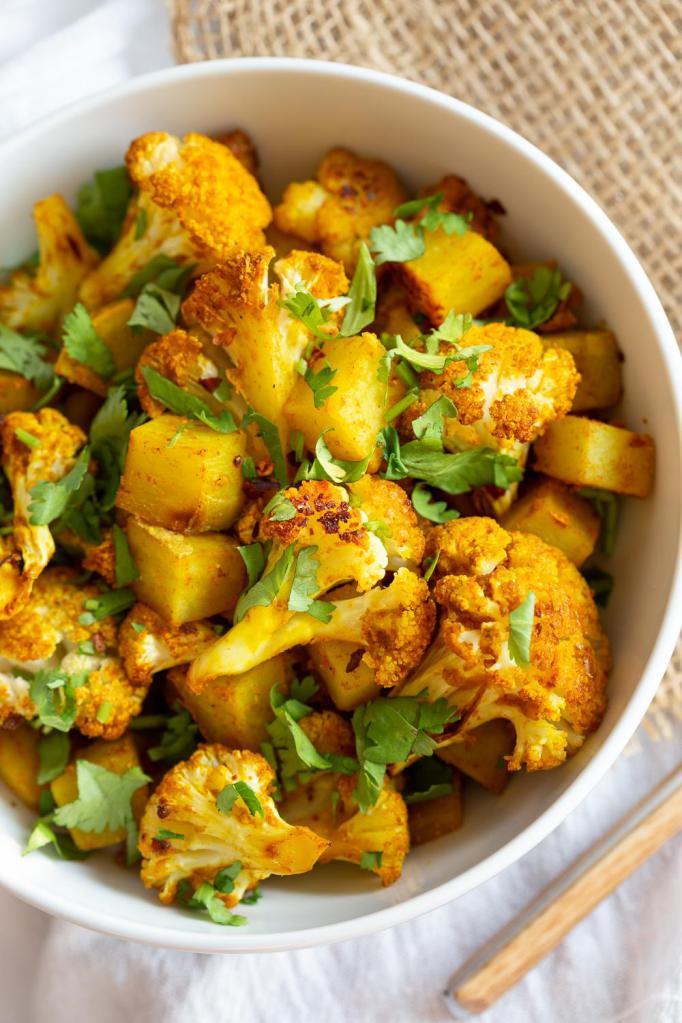 Aloo Gobi · Fresh cauliflower and potatoes sautéed in mild spices with tomatoes, onion, ginger, garlic, and Indian herbs.
