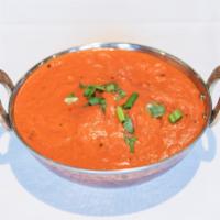 Chicken Tikka Masala · Composed of grilled chunks of chicken enveloped in a creamy spiced tomato sauce.