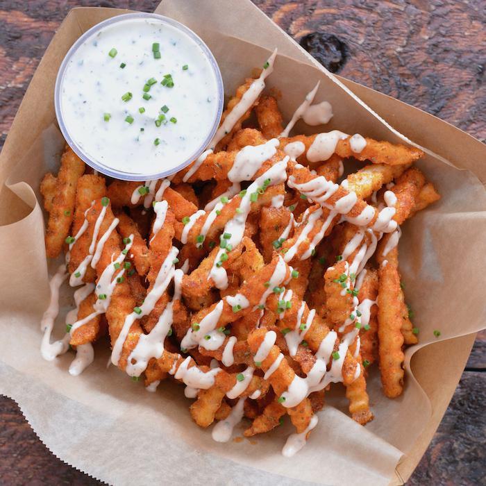 Cajun Garlic Fries with Homemade Buttermilk Ranch · Crispy crinkle cut fries tossed with Tendies’ Cajun garlic seasoning and served with homemade buttermilk ranch
