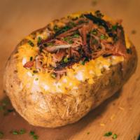 Legendary Spud · Loaded spud topped with butter, sour cream, cheese, chives and choice of meat.
