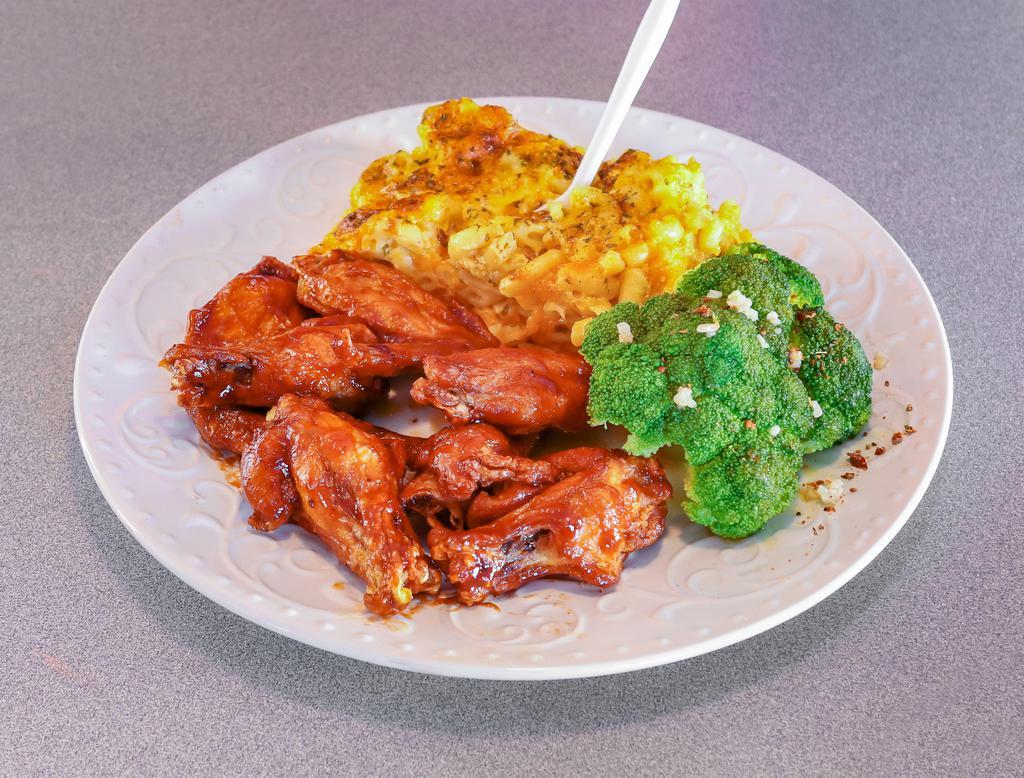 Fried Chicken Wing Ding with 2 Sides · 6 house seasoned chicken wing portions, which includes your choice of sauce and served  with 2 sides.

Choice of wing sauce: Naked, Honey Chipotle,  Garlic Parm, Sweet Chili Thai, Lemon  Pepper,  or Garlic Mojo