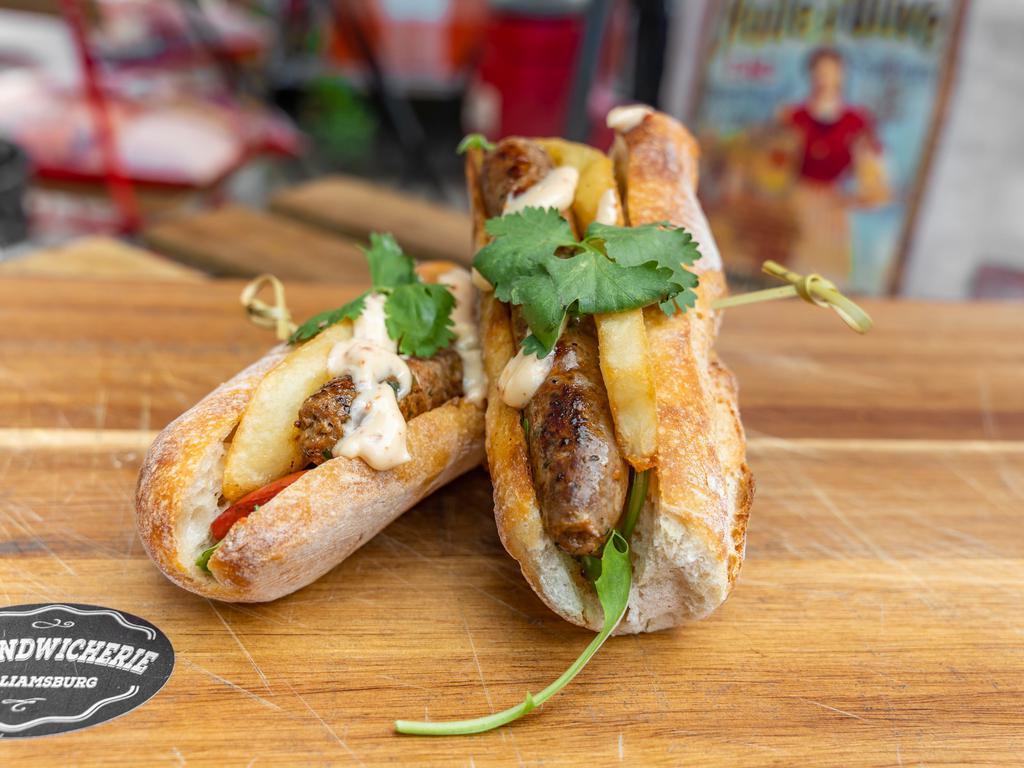 Lamb Sausage Sandwich ·  Organic 100% lamb sausage, sauted peppers onions, cilantro, fries, arugula, harissa mayo sauce, and organic baguette bread.