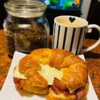 Croissant, egg, bacon & cheese. · Served on a flaky French pastry.
