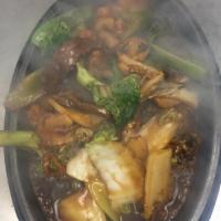 SL4. Sizzling Triple Delight · Prawns, beef and chicken stir fried with vegetables in a light brown sauce served on a sizzl...