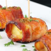 Bacon Wrapped Pineapple · Six pieces. Pan fried bacon wrapped pineapple.