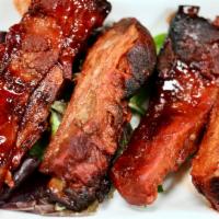 Spare Ribs · 4 pieces. A cut of meat from the bottom section of the ribs.