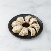 8 Pieces Fried Dumplings · Mixture of pork and cabbage dumplings pan fried and boiled.