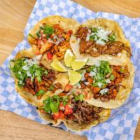 Carnitas Taco · Served with onion and cilantro.