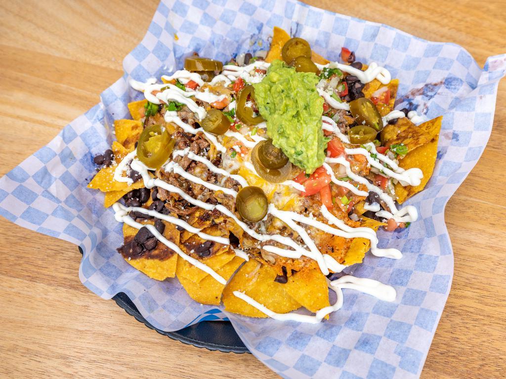 Nachos with Meat · Choice of meat, served with black or pinto beans, Jack and cheddar cheese topped with pico de gallo, sour cream, guacamole and jalapenos.