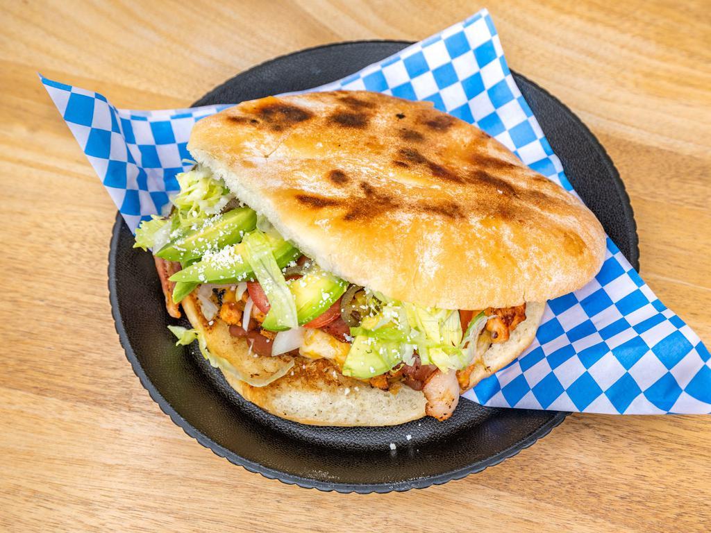 La Torta · Fresh bread sandwich, choose any house meat served with mayonnaise, lettuce, onion, tomato, avocado, jalapenos, cheese and bacon.